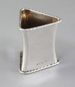 A 1930's Arts & Crafts silver waisted triangular napkin ring, by Omar Ramsden, hallmarked London