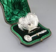 A cased Victorian sterling silver sugar bowl and matching sifter spoon, by Wakely & Wheeler, with