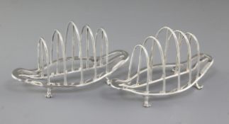A pair of George V silver toast racks, by George Howson, hallmarked Sheffield 1930, of boat shape,