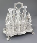 A Victorian silver eight bottle cruet stand and eight original bottles, by Walter & John Barnard,
