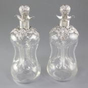 A pair of Edwardian silver mounted waisted glass decanter and stoppers, by Alexander Clark
