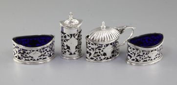 A George V four piece pierced silver condiment set, by Stewart Dawson & Co, hallmarked Birmingham