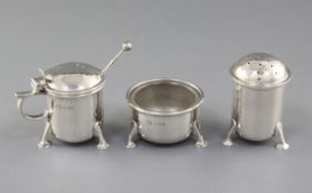 A George V Arts & Crafts planished silver three piece condiment set, by Albert Edward Jones,