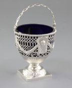 A George III silver swing handled sugar basket with blue glass liner, by Charles Chesterman,