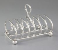 A Victorian silver seven bar toast rack, by Richard Sibley II, hallmarked London 1872, on four