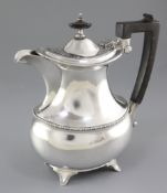A George V silver hot water pot, by Elkington & Co,. hallmarked for Birmingham 1917, with beaded