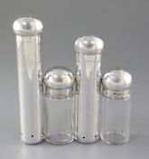 Four late Victorian dressing table cylindrical jars, two in solid silver with domed tops and two