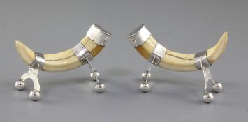 A pair of silver mounted boar tusk knife rests, by Army & Navy Co-Operative Society Ltd, London,