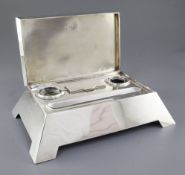 A stylish Edwardian silver inkstand with hinged cover, by Hukin & Heath, hallmarked Birmingham 1907,