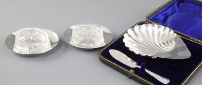 A cased Victorian silver scallop shaped butter dish and knife, hallmarked Birmingham 1894, length