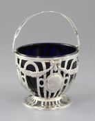 An Edwardian pierced silver sugar basket and blue glass liner, by Elkington & Co, hallmarked