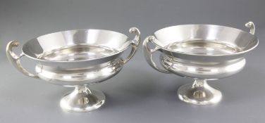 A pair of Edwardian Art Nouveau silver two handled pedestal bowls, by James Aitchison, hallmarked