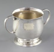 A George V Arts & Crafts silver two handled cup, by Guild of Handicrafts, hallmarked London 1916, it