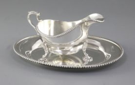A 1950's/1960's silver sauce boat and similar stand, by Adie Brothers, Birmingham, 1959, stand,
