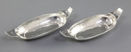 A pair of Edwardian Arts & crafts silver oval navette shaped dishes, by Liberty & Co, hallmarked