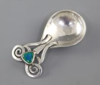 A good Edwardian Arts & Crafts planished silver and enamel caddy spoon, by Omar Ramsden & Alwyn