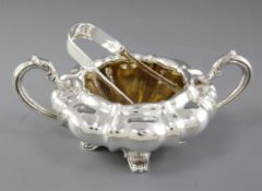 A William IV silver two handled sugar bowl, hallmarked London 1831, maker “CE”, of lobed circular