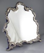 A large George V repousse silver mounted dressing table easel mirror, by William Comyns,