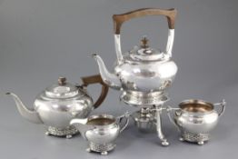 A George V planished silver Arts & Crafts three piece tea set, by Albert Edward Jones, hallmarked