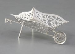 An Edwardian Art Nouveau silver novelty bon bon basket, in the form of a wheelbarrow, by