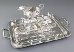 A 1930's silver asparagus draining dish with asparagus servers and sauce boat, by Goldsmiths &