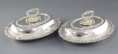 A pair of ornate Victorian oval silver plated entrée dishes with covers, mark of Ellis & Co?, length