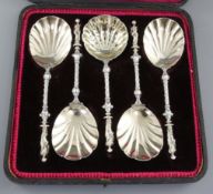 A cased set of four Victorian silver parcel gilt fruit serving spoons and a sugar sifter, hallmarked