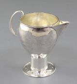 An Edwardian Arts & Crafts silver sparrow beak cream jug, by Albert Edward Jones, hallmarked