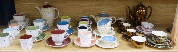 A collection of mixed Susie Cooper tea and coffee wares decorated with lustre stars, and bronze
