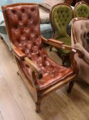 A Victorian buttoned leather scroll armchair