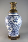 A Chinese blue and white 'antiques and lotus' vase, Qing dynasty, Kangxi period, with gilt metal rim