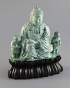 A Chinese turquoise matrix group of a buddha and attendants, circa 1900, with hardwood stand, 6.