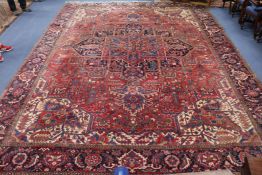 A large Heriz red ground carpet, 470 x 355cm