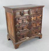 A Charles II oak chest with moulded top above two short and three long drawers, on bracket feet (