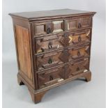 A Charles II oak chest with moulded top above two short and three long drawers, on bracket feet (