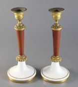 A pair of 19th century French ormolu mounted simulated porphyry candlesticks with Paris porcelain