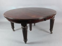 A large Victorian mahogany extending dining table with four leaves on reeded turned tapered legs 4ft