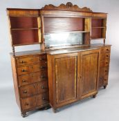 An unusual Regency cedarwood breakfronted side cabinet, circa 1815, the gallery with a shaped