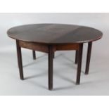 A George III mahogany double gateleg table on moulded square legs opens to 2ft 4in. x 4ft 11in.