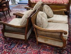 A three piece walnut bergere suite, with single caning