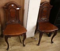 A pair of Victorian mahogany hall chairs