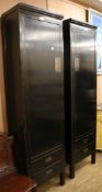 A pair of Lumbok Chinese style black lacquered hanging cupboards, W.55cm