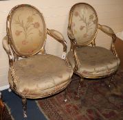 A pair of 19th century French giltwood fauteuils with moulded frames and floral pattern upholstery