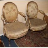A pair of 19th century French giltwood fauteuils with moulded frames and floral pattern upholstery