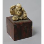 A Japanese ivory figure, 1in., on marble plinth