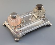 An oblong silver inkstand, with central handle and two inkwells, maker Martin, Hall & Co,