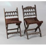 A pair of Continental walnut folding stools carved with biblical subjects (a.f.)https://www.