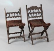 A pair of Continental walnut folding stools carved with biblical subjects (a.f.)https://www.