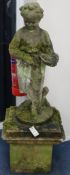 A weathered composition garden statue modelled as a girl carrying a basket of flowers, on a