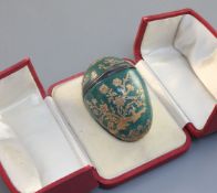 A silver mounted enamel 'egg' bonbonniêre, French, mid 18th century, decorated in raised gilding
